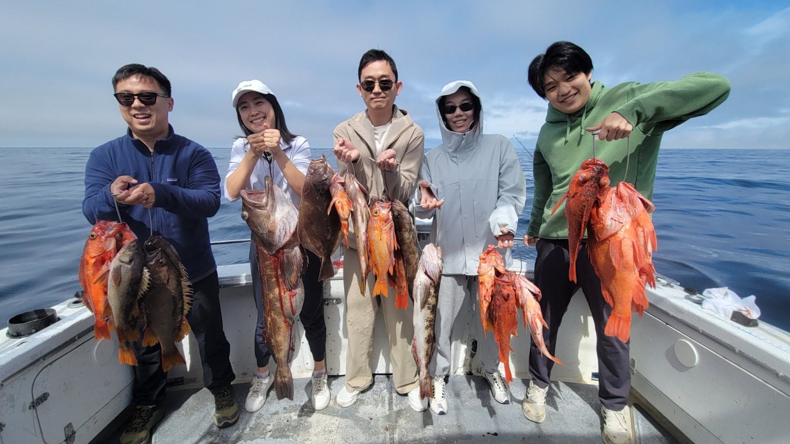 Group of anglers with catch on boat